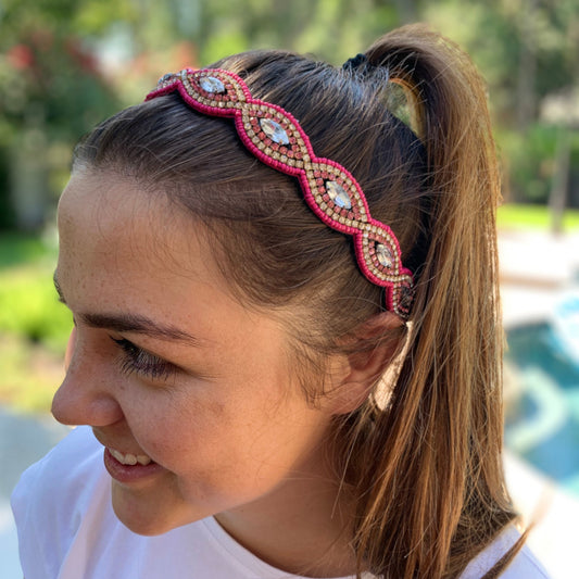 Bright pink beads surround a dazzling crystaL on this adjustable beaded headband